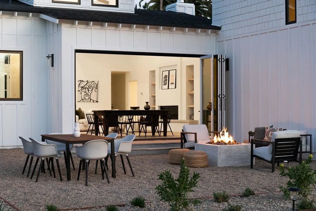 Outdoor fire pit lounge with gravel patio and open indoor-outdoor living space