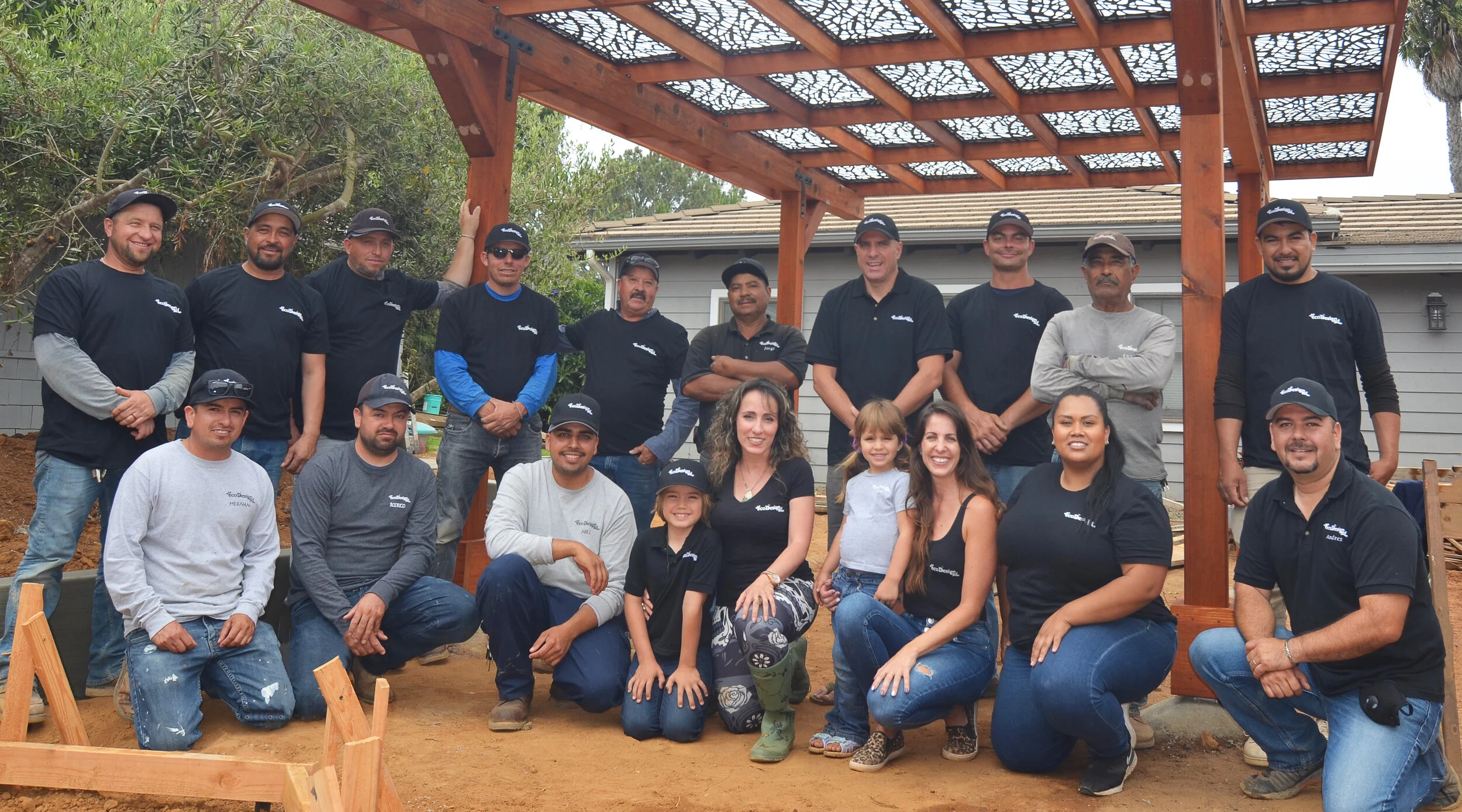 The EcoDesignSD crew gathered under a newly built redwood pergola on a San Diego job site